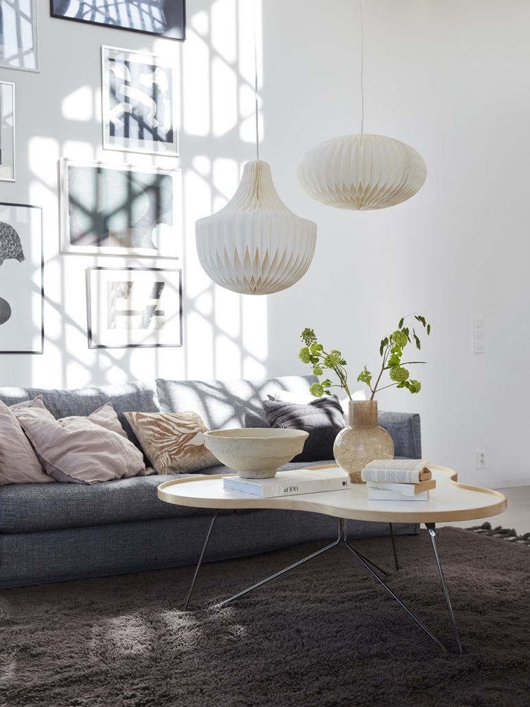 Białe plisowane lampy wiszące w stylu japandi w salonie